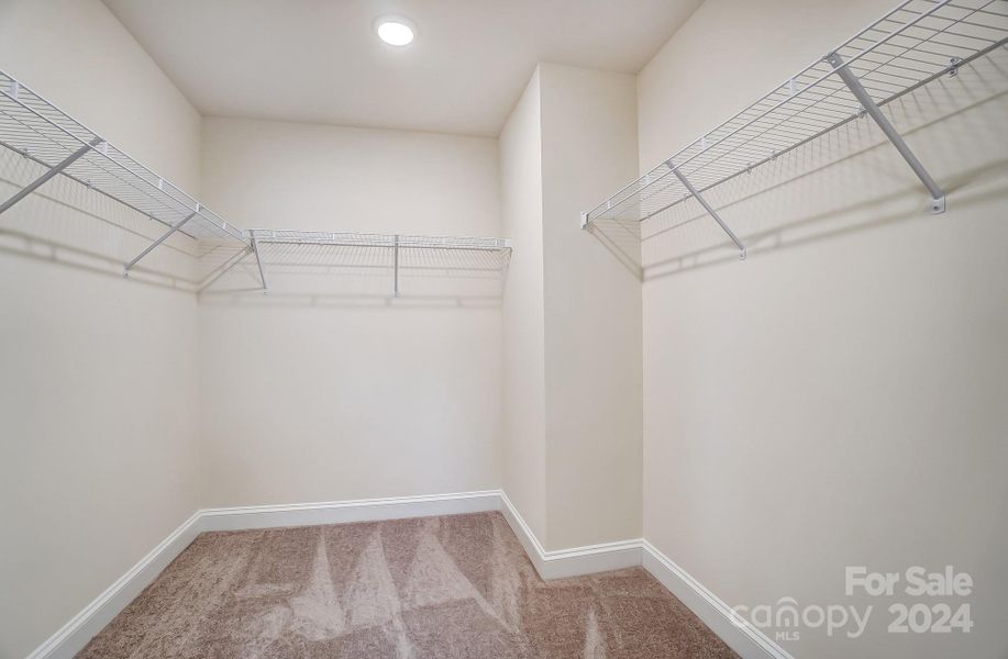 Walk in closet in primary bedroom