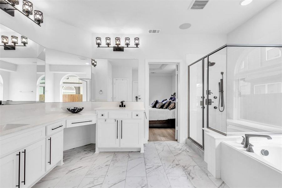 Bathroom with independent shower and bath, dual vanity,  linen closet, and bidet