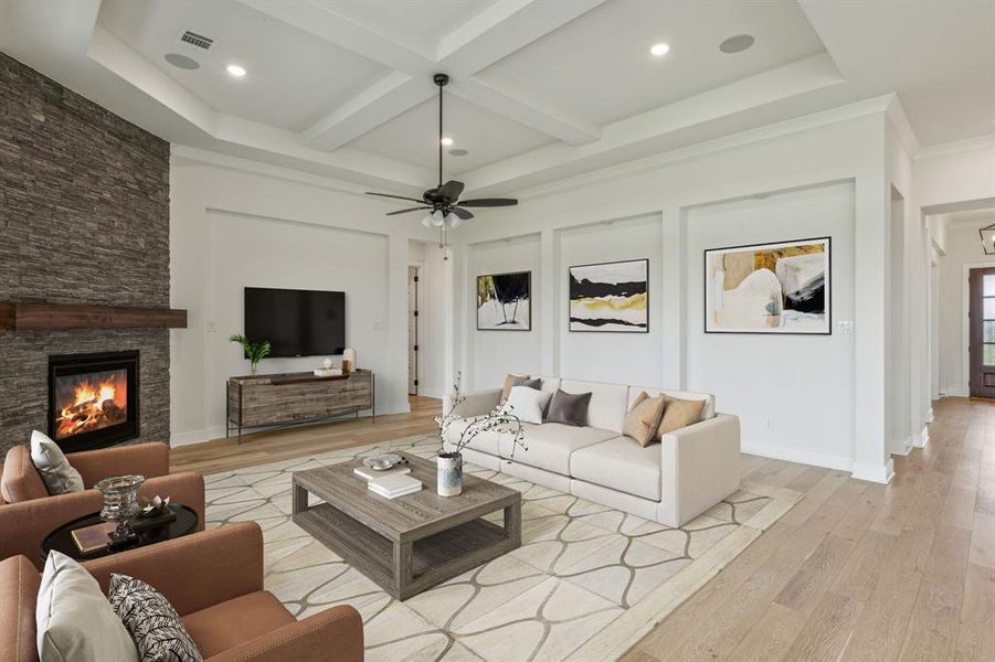 Living room with light wood-type flooring, coffered ceiling, a stone fireplace, ceiling fan, and beam ceiling *VIRTUAL STAGING