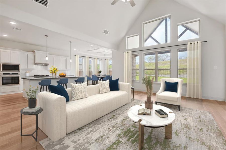 Living room with high vaulted ceiling, light hardwood / wood-style floors, and ceiling fan