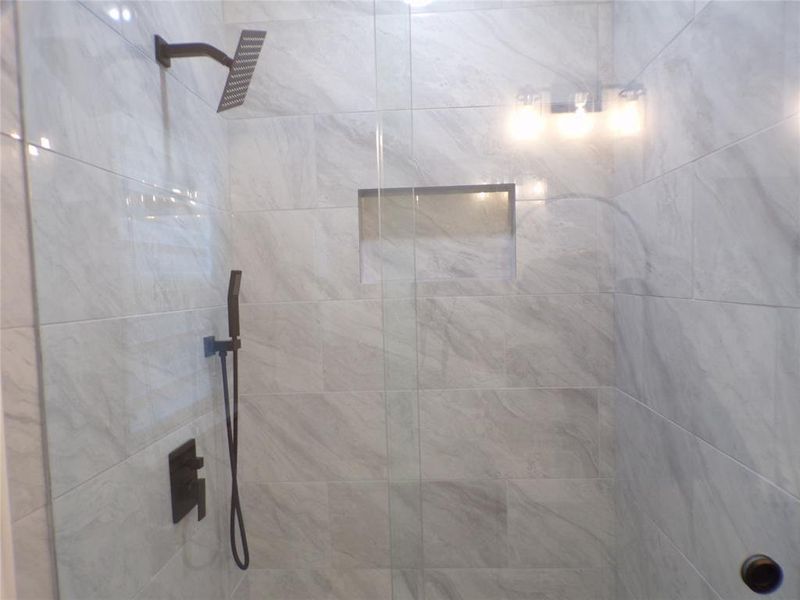 Bathroom featuring tiled shower