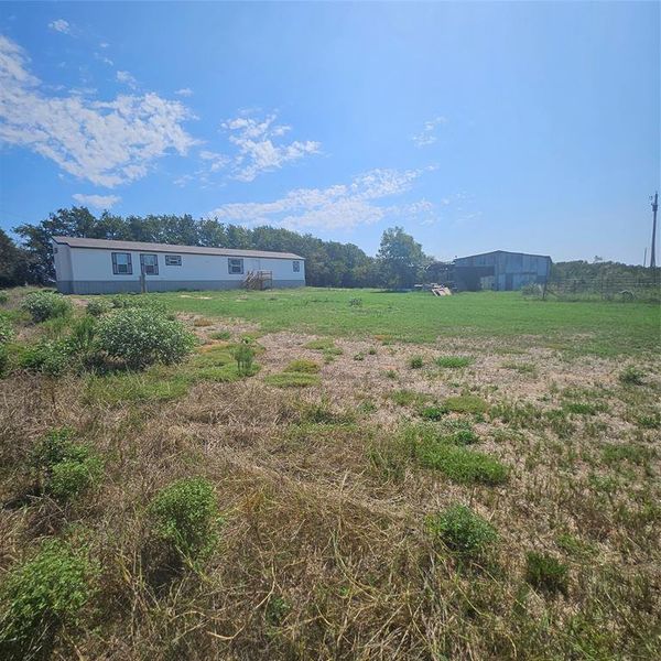 Out building, barn or loafing shed between homes.