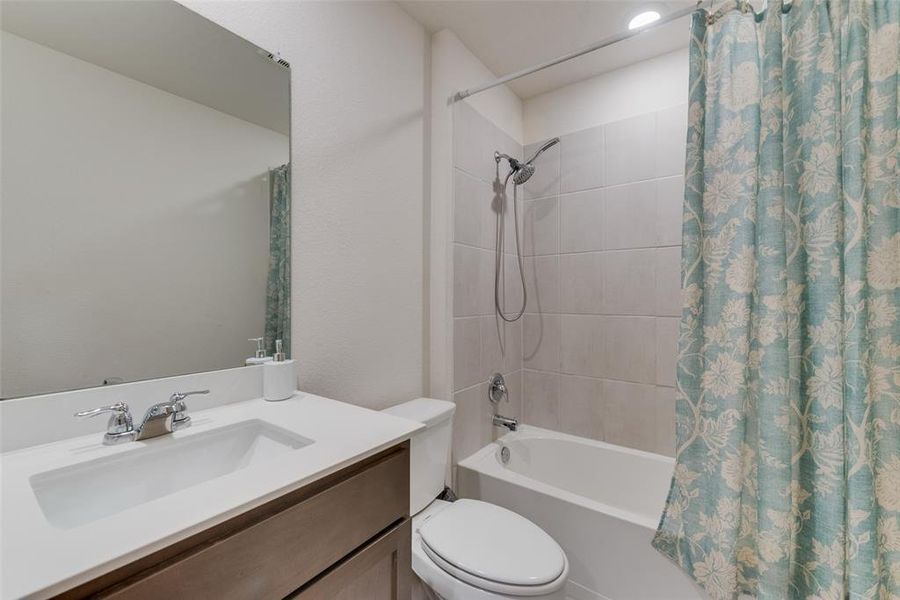 Full bathroom with vanity, toilet, and shower / bath combo