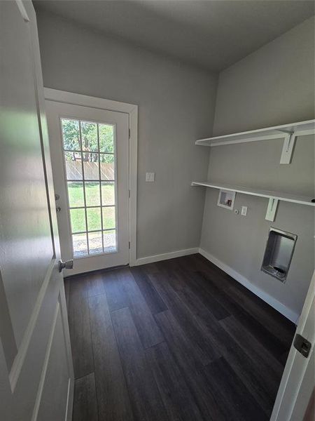 Clothes washing area featuring washer hookup and dark hardwood / wood-style flooring