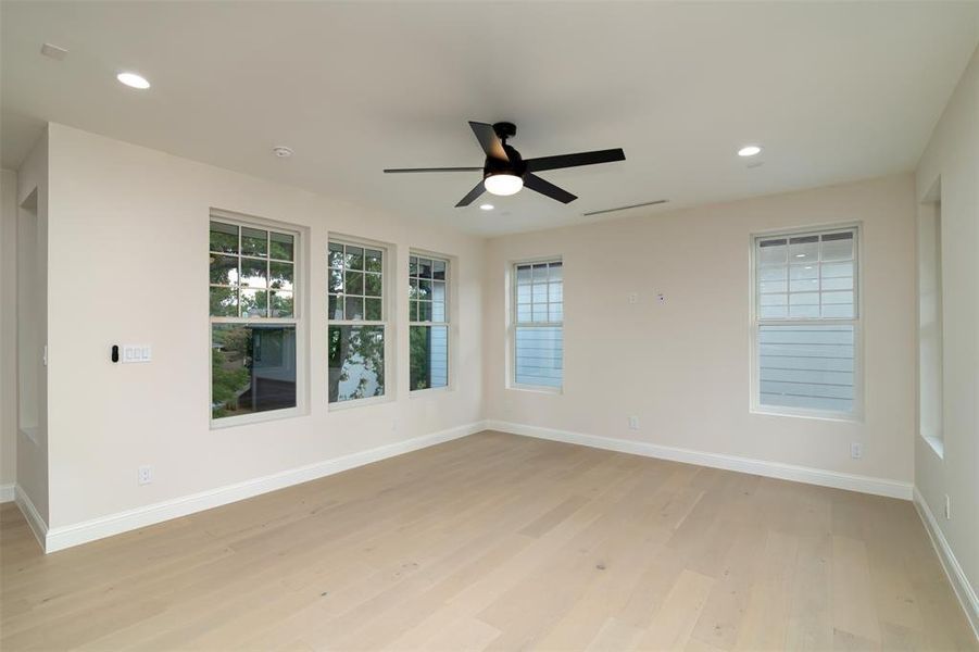 Spare room with light wood-type flooring and ceiling fan