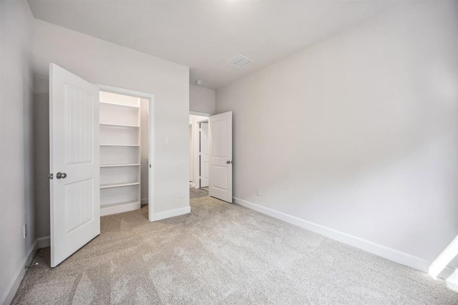 Both Secondary Bedrooms boast walk-in closets with custom shelving.