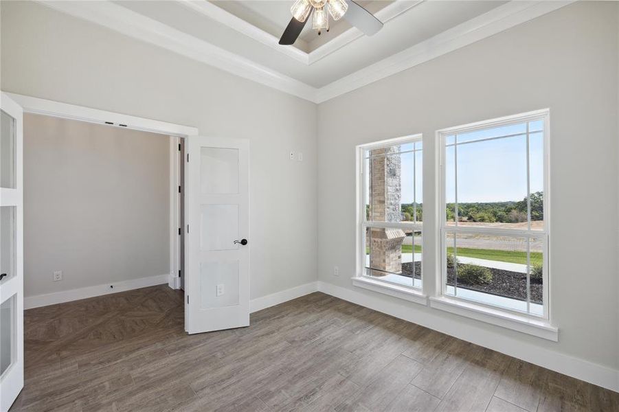 Unfurnished room featuring ceiling fan, hardwood / wood-style flooring, and crown molding