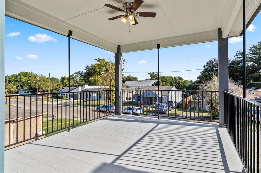 View of patio featuring ceiling fan and a balcony