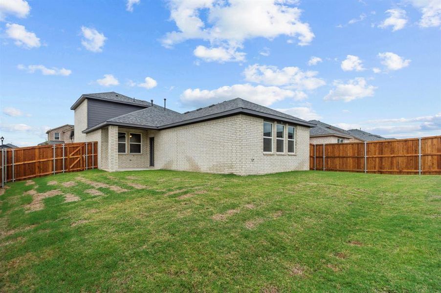 Rear view of property featuring a yard