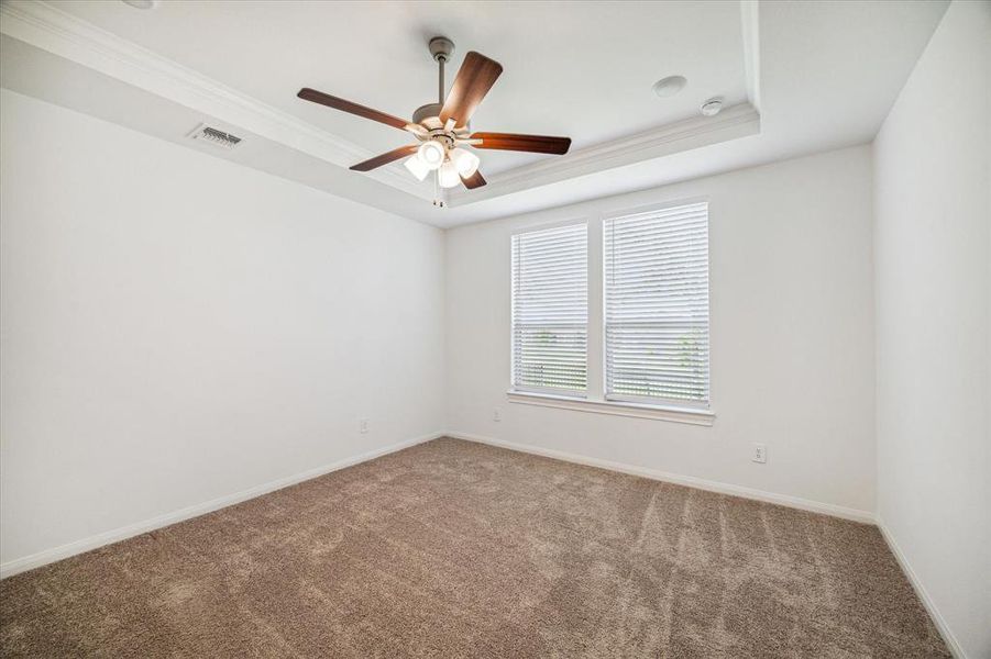 Primary bed is roomy with a ceiling fan and vaulted ceiling-nice!