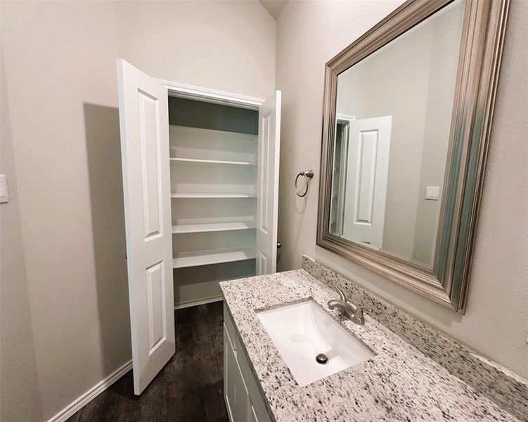 Granite counters, framed mirror & a linen closet for extra storage.