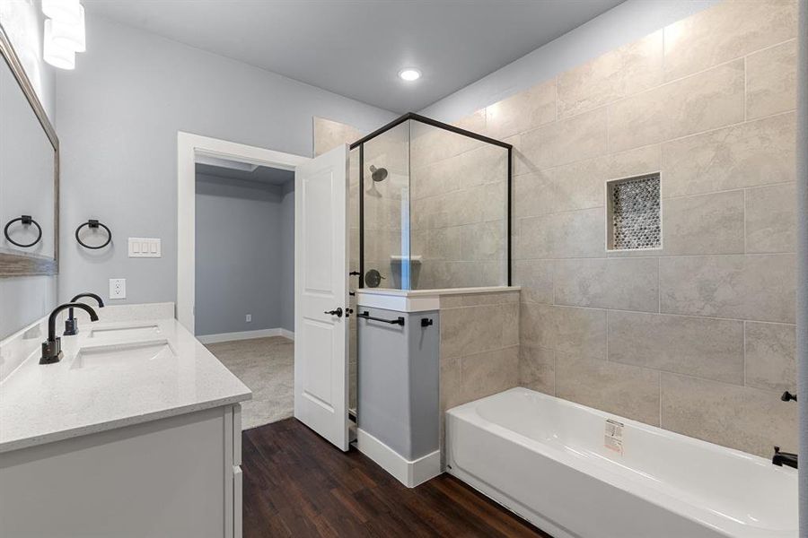 Bathroom with vanity, separate shower and tub, and wood-type flooring