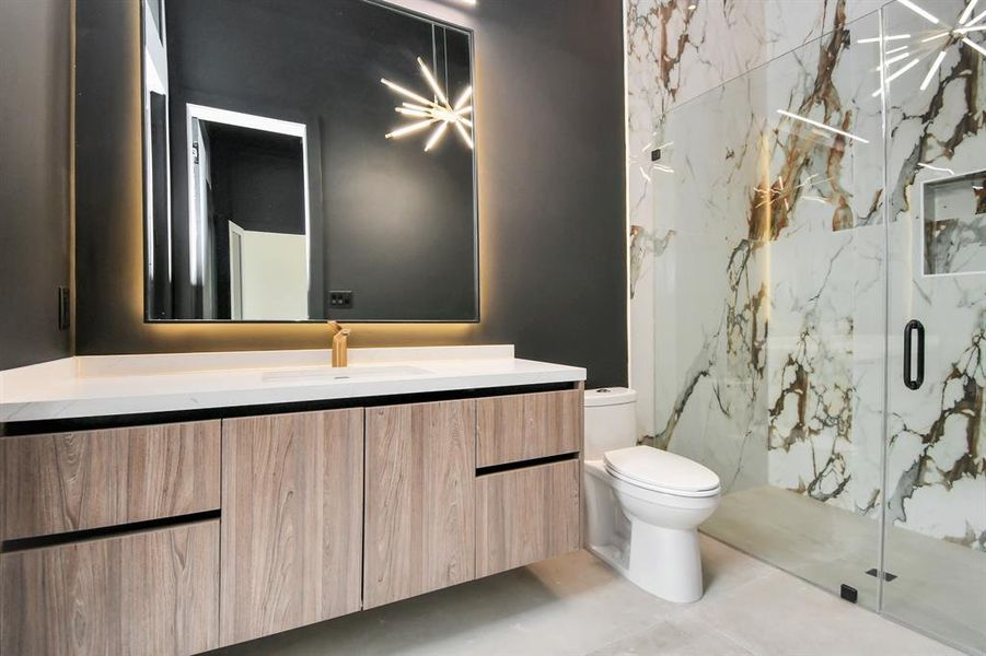 Elegant pool bathroom with modern finishes. Direct access to outside area.