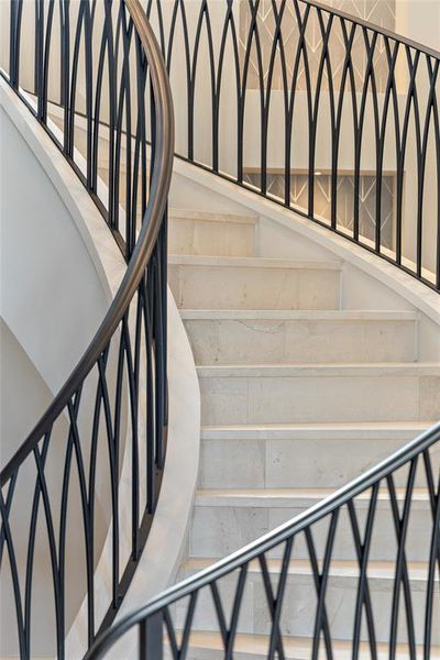Experience the timeless elegance of the spiral wrought iron staircase, where sweeping curves and ornate balusters create a sense of drama and grandeur.