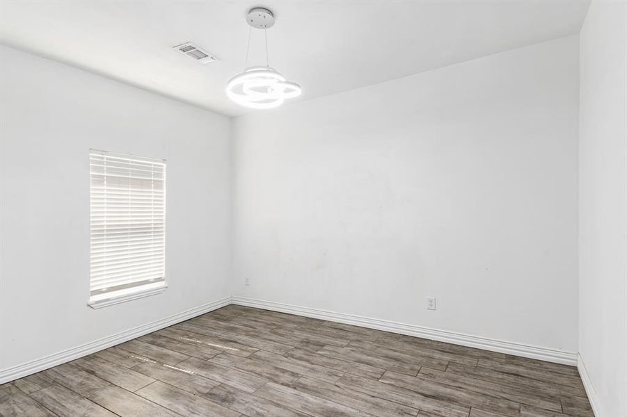 Empty room with hardwood / wood-style floors