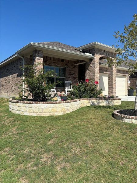 View of front of home with a garage and a front lawn