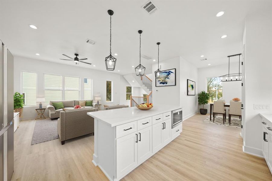 Virtually Staged: This photo highlights the open space - also featuring the flex space adjacant the kitchen. A great space for a dining room, home office, or bonus living space.