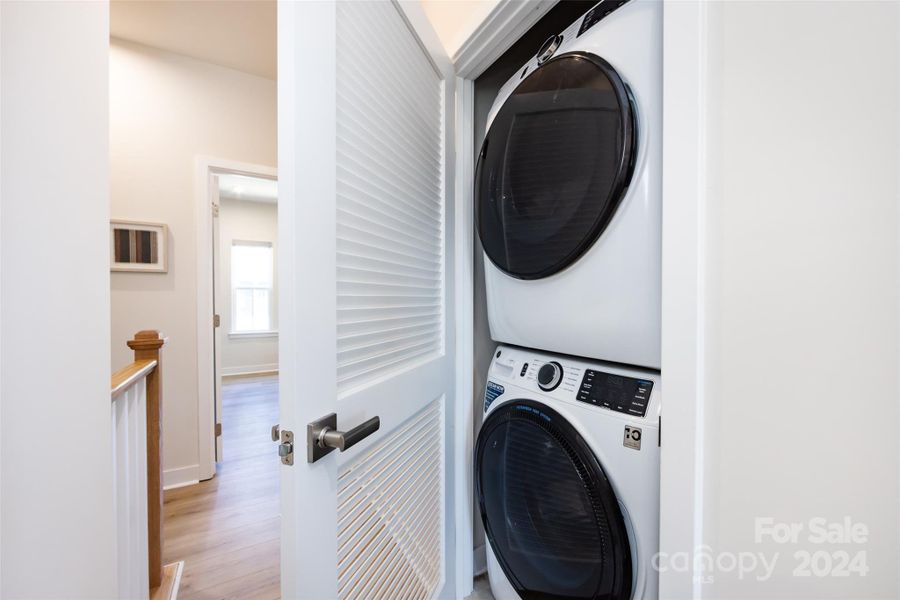 Laundry between the primary and secondary bedrooms. Washer/dryer convey!