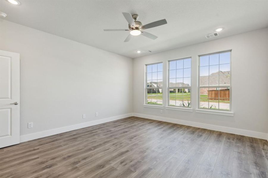 Empty room with ceiling fan and hardwood / wood-style floors