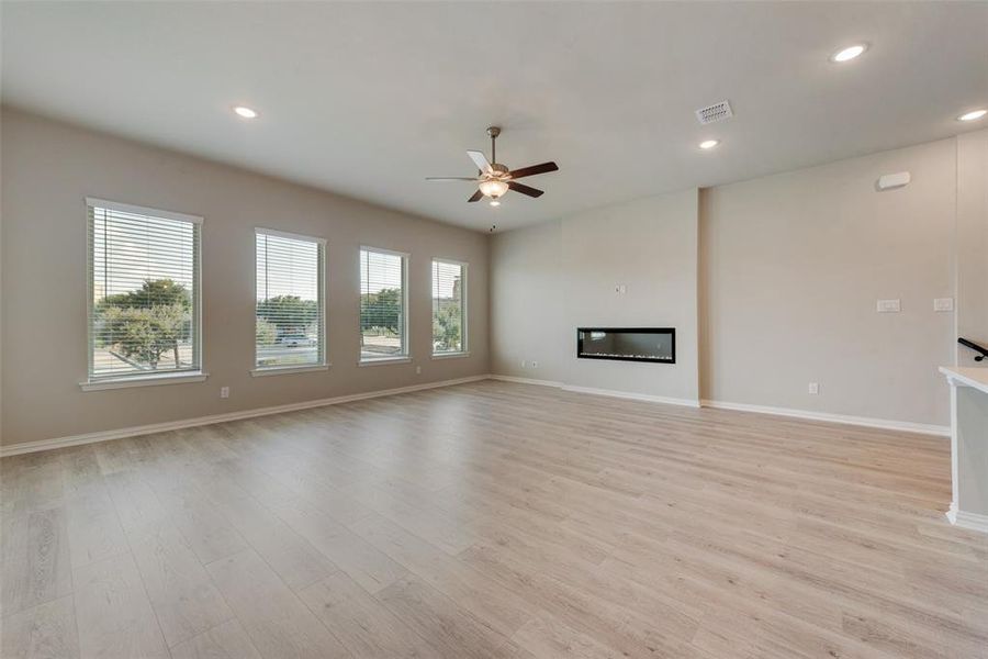 Unfurnished living room featuring light hardwood / wood-style floors and ceiling fan
