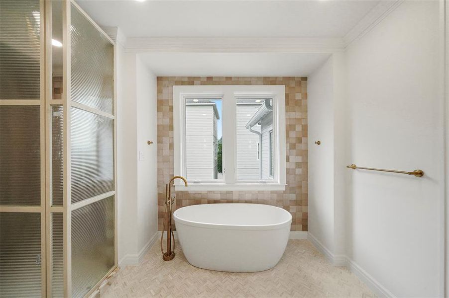 Modern bathroom featuring a perfect soaking tub, neutral tiles, and a custom steel-doored shower, ideal for relaxing with a book and candles.