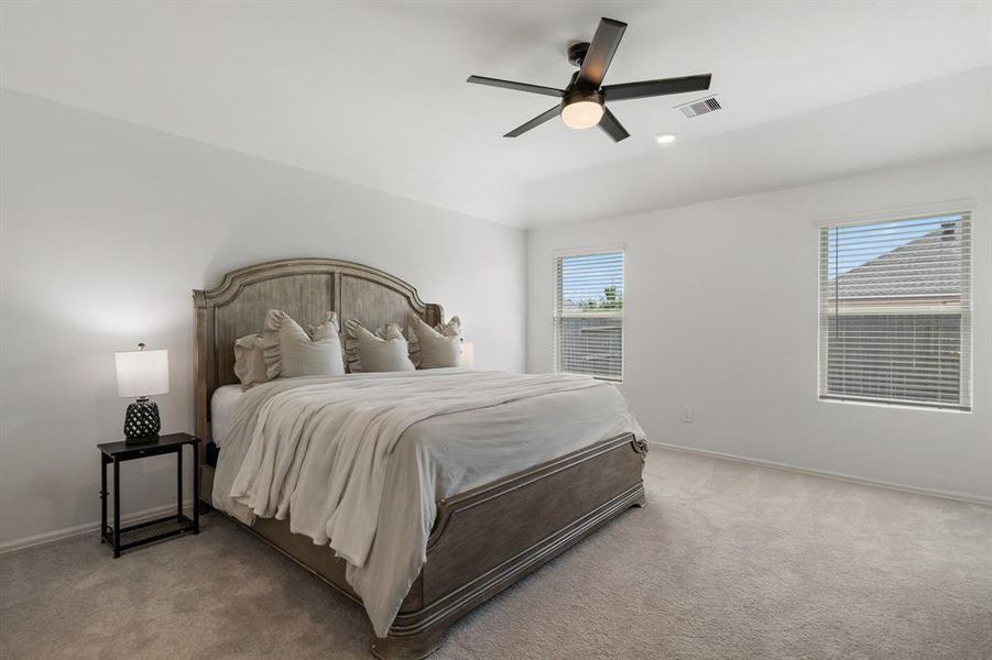 Primary bedroom is tucked away off the back of the home and as a wall of windows overlooking the backyard.