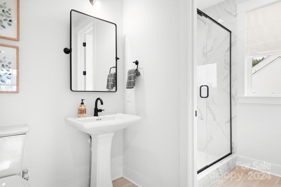 Main level full bath with access to the foyer and main floor bedroom.  Beautiful tile work in the shower that goes up to the ceiling.