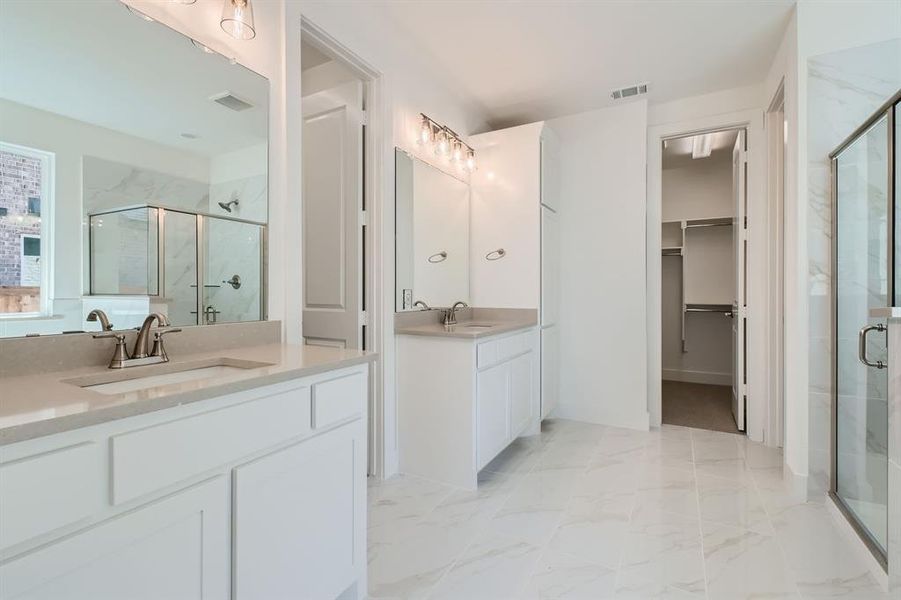 Bathroom with vanity and a shower with shower door