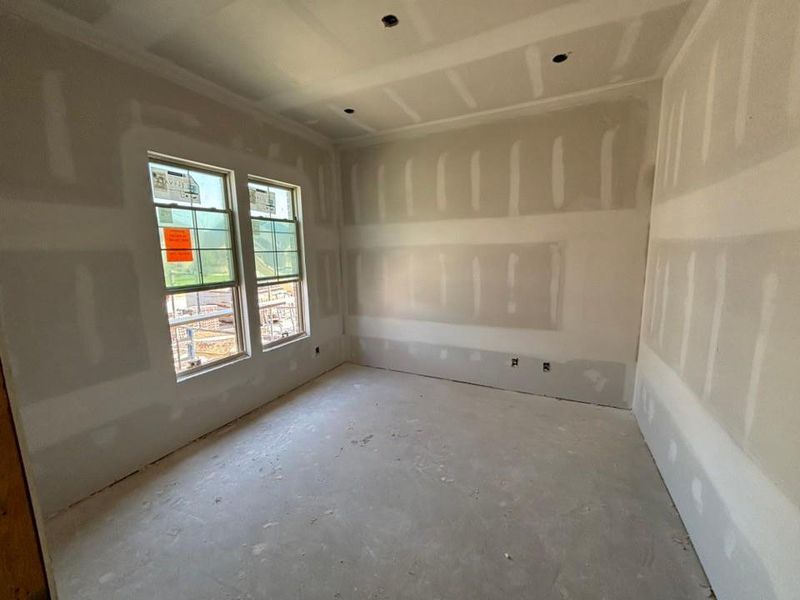 Spare room featuring concrete floors and plenty of natural light