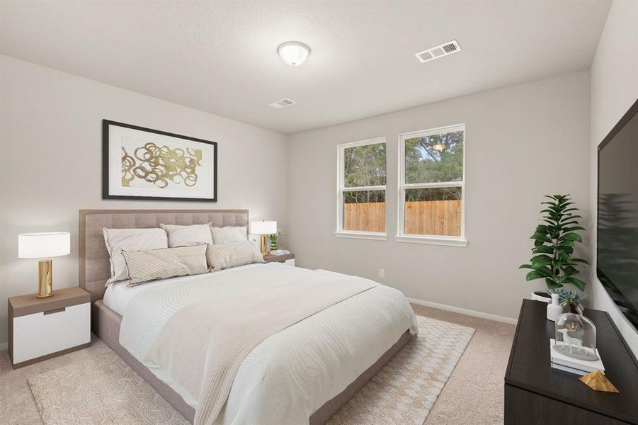 The primary bedroom is generously sized, creating a tranquil and spacious retreat that offers ample room for relaxation. Featuring plush carpet, high ceilings, fresh paint, and large windows that lets in natural lighting throughout the day.