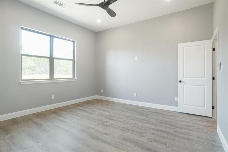 Unfurnished room with light hardwood / wood-style flooring and ceiling fan