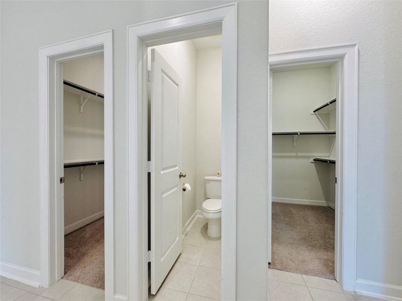 Primary two closets with toilet room in the middle