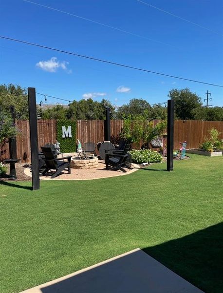 View of yard featuring a patio and a fire pit