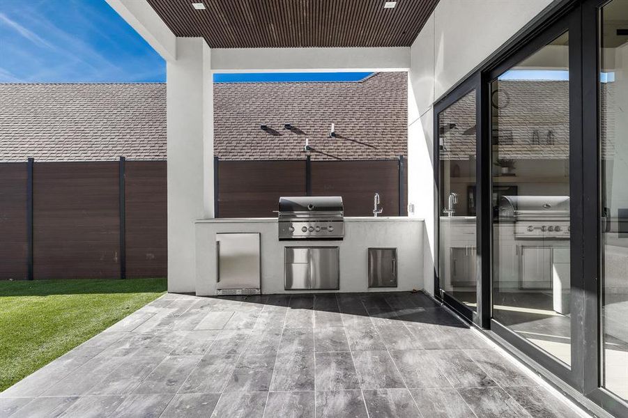 View of patio featuring area for grilling and sink