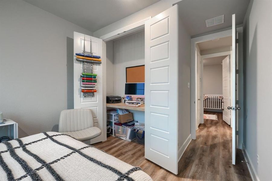 Bedroom with light wood-type flooring and radiator heating unit