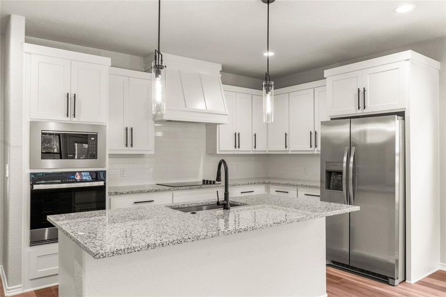 with shaker cabinets, granite countertops, built in oven and microwave, cooktop and island seating--will include refrigerator