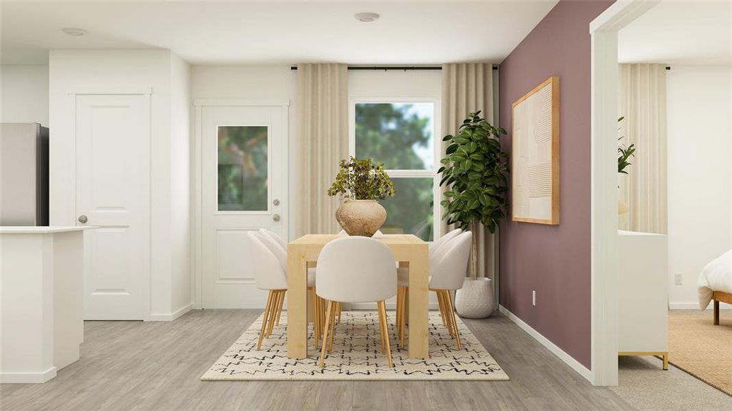 Dining area with light hardwood / wood-style flooring