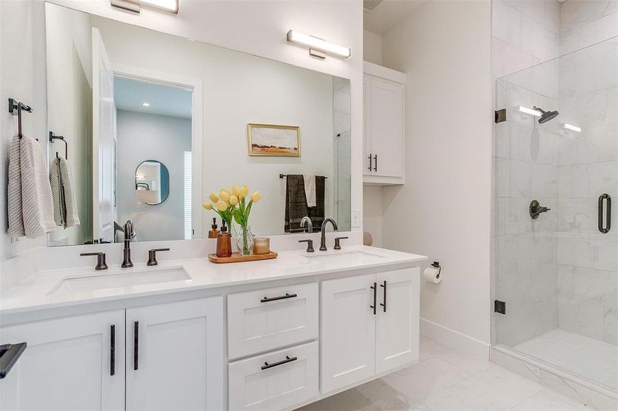 Spacious master bathroom featuring dual vanities and abundant natural light, creating a bright and luxurious retreat.