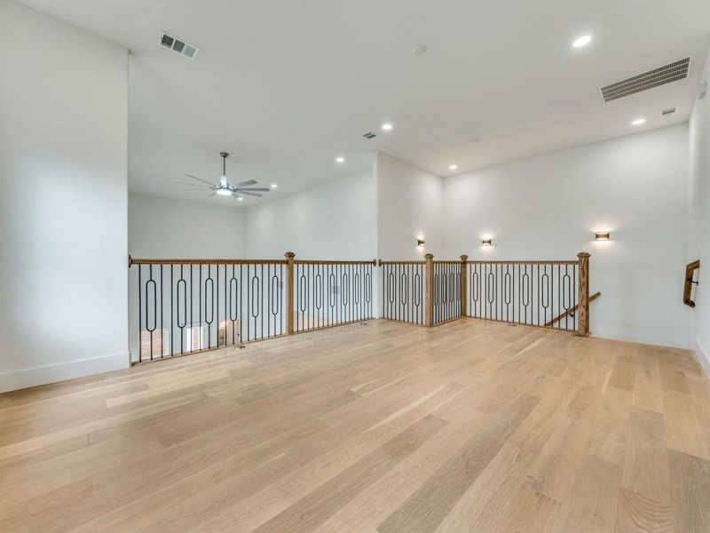 Unfurnished room with ceiling fan and light hardwood / wood-style flooring