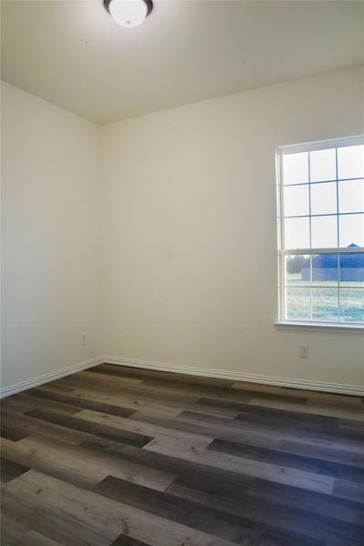 Unfurnished room with dark hardwood / wood-style floors