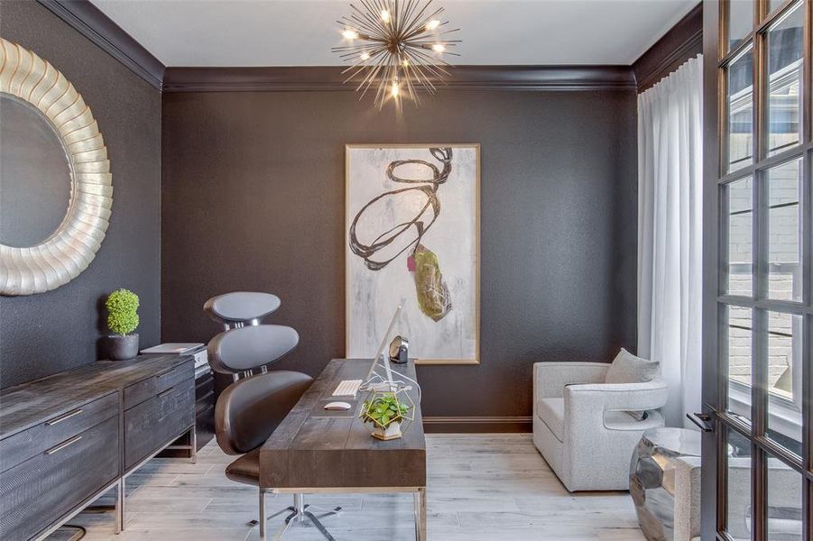 Living area featuring a healthy amount of sunlight, a chandelier, and light hardwood / wood-style floors