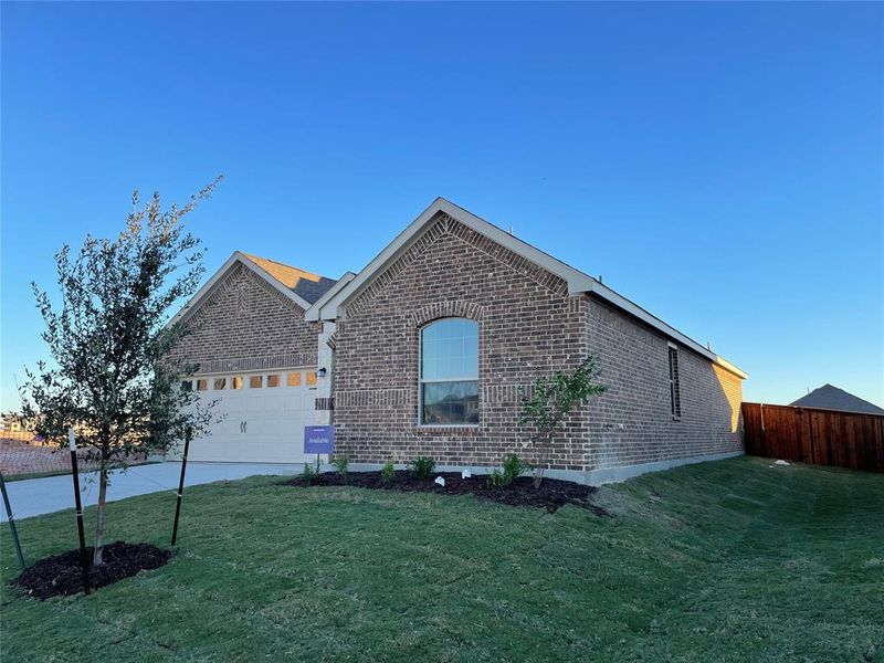 View of front facade with a front yard and a garage