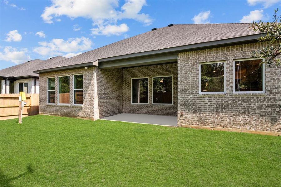 Large covered rear patio is plumbed for gas grill and has speaker pre-wire and camera pre-wire. Full brick exterior. Full gutters. Fully sodded w/sprinklers.