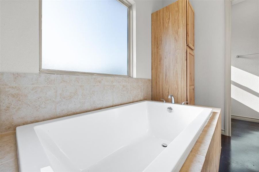 Bathroom featuring a healthy amount of sunlight and a bathing tub