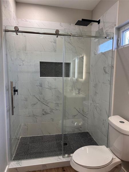 Glass shower door. RAIN SHOWER. Built in shampoo rack.