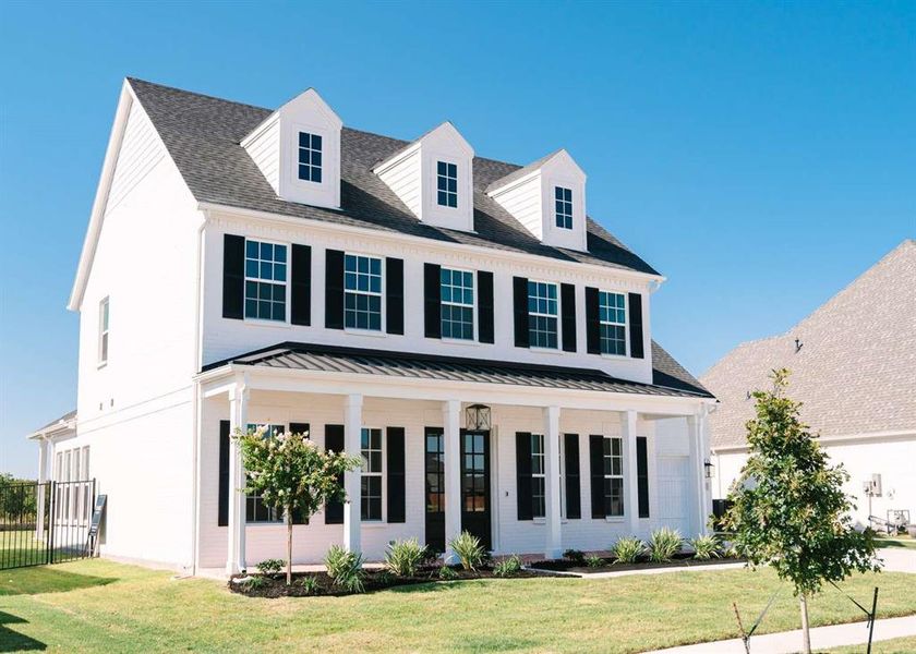 View of front of home featuring a front yard and a porch