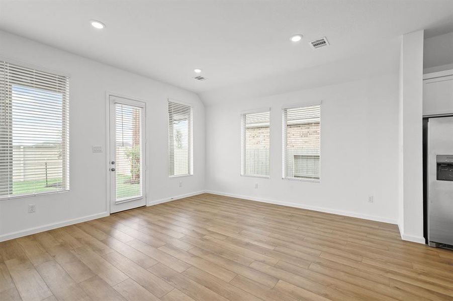 Dining room has natural light from the backyard, and a glass door leading outside, with an inviting covered patio with recessed lighting, perfect place for the summer BBQ with your family or friends.