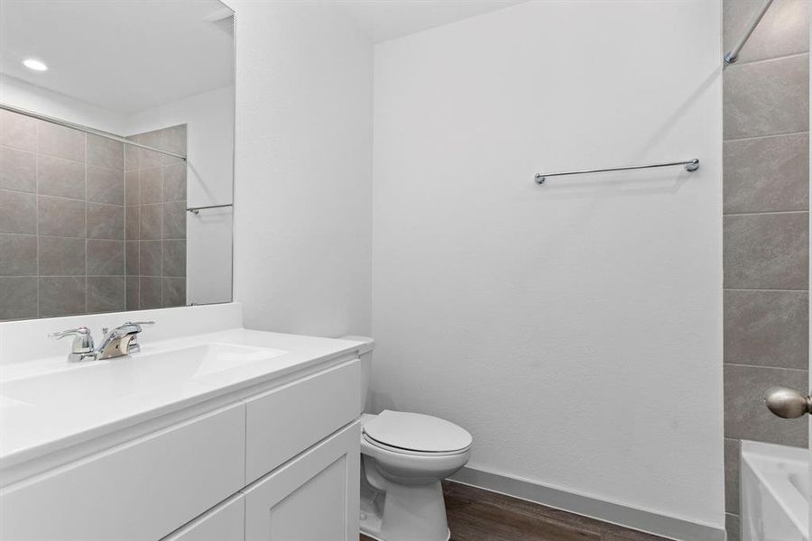 The Guest Bathroom has Large Plank Vinyl like Wood Floors, Shower and Tub Combination with beautiful Tile Surroundings, Large Vanity with Smooth Top Surface and all bathrooms has Elongated commodes! **Image Representative of Plan Only and May Vary as Built**