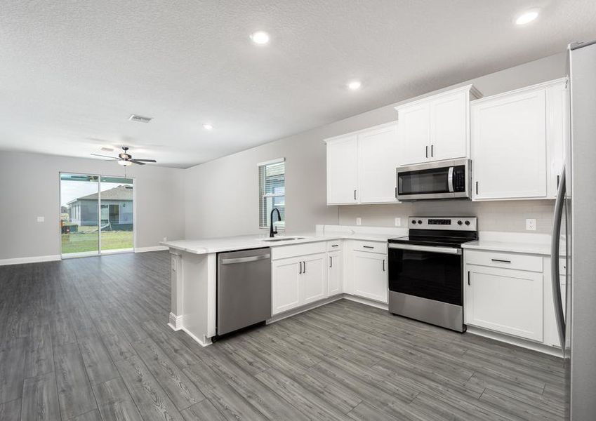 The kitchen leads to the spacious family room