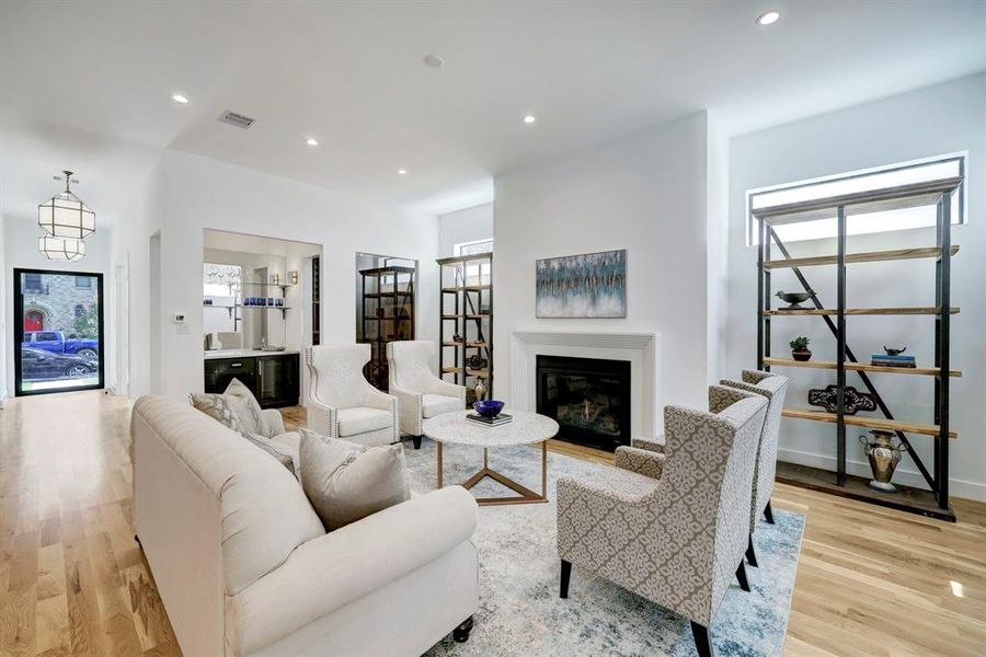 Great room with 11 ft. ceilings and fireplace highlighted by wine room